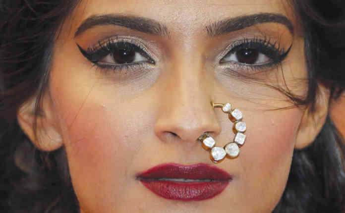 Bollywood actress Sonam Kapoor poses on the red carpet as she arrives for the screening of the film 'The Great Gatsby' and for the opening ceremony of the 66th Cannes Film Festival in Cannes
