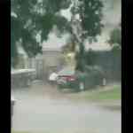 man-washing-car-in-storm
