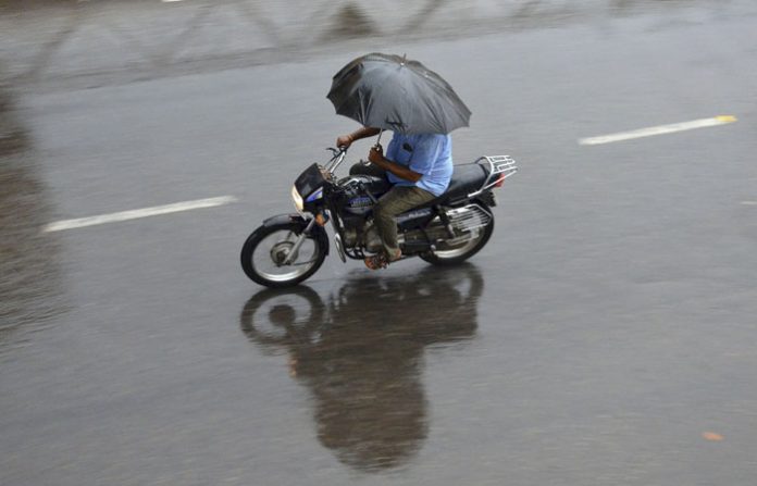 heavy-rain-man-riding-bike