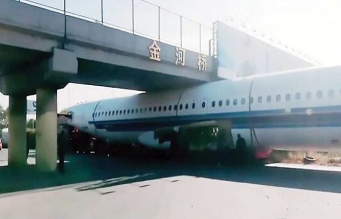 aeroplane-stuck-under-bridg