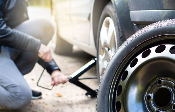 driver-changing-spare-tyre-after-accident-broken-royalty-free-image-852475670-1548440248