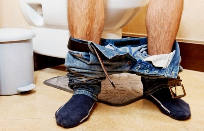 man-seating-in-toilet